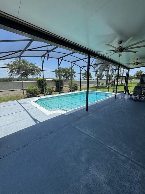 5435 Bryce Canyon Dr, Kissimmee, FL 34758 - swimming pool with a ceiling fan, glass enclosure, and a patio area