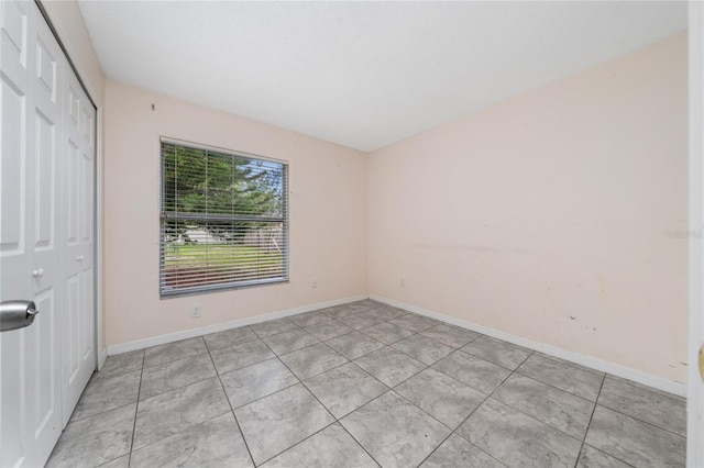 11649 Crescent Pines Blvd, Clermont, FL 34711 - unfurnished bedroom featuring a closet and light tile patterned floors