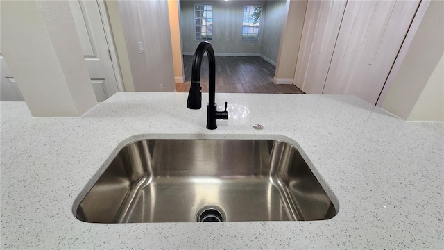 235 Goldenrain Dr Unit 102, Kissimmee, FL 34747 - kitchen view of wood finished floors and light stone countertops
