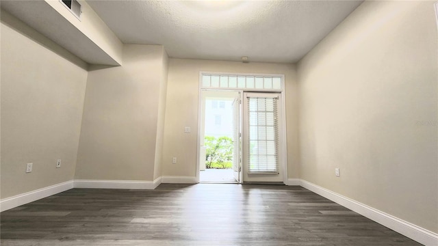 235 Goldenrain Dr Unit 102, Kissimmee, FL 34747 - spare room with dark wood-style flooring and a textured ceiling