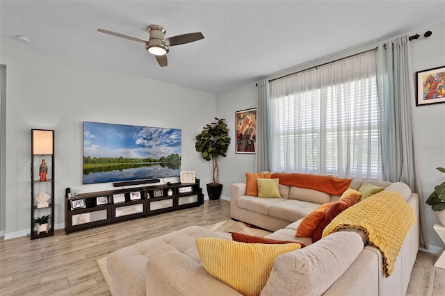 2436 Bulrush Dr, Saint Cloud, FL 34769 - living area featuring a ceiling fan, wood finished floors, and a textured ceiling