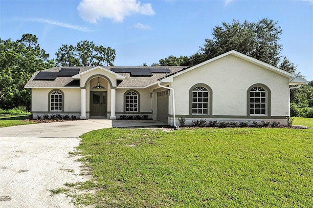 4635 Deer Run Rd, Saint Cloud, FL 34772 - mediterranean / spanish home featuring a front lawn, stucco siding, driveway, and roof mounted solar panels