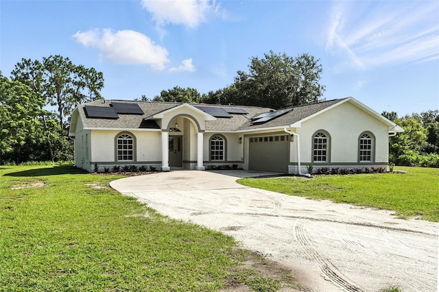 4635 Deer Run Rd, Saint Cloud, FL 34772 - view of front of house featuring stucco siding, concrete driveway, an attached garage, and roof mounted solar panels
