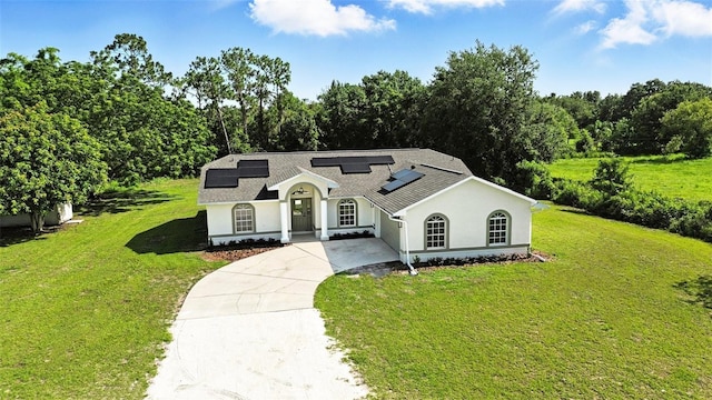 4635 Deer Run Rd, Saint Cloud, FL 34772 - mediterranean / spanish house with driveway, roof mounted solar panels, a front yard, and stucco siding