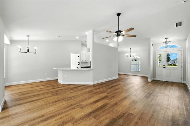 4635 Deer Run Rd, Saint Cloud, FL 34772 - unfurnished living room with a chandelier, light wood-style floors, vaulted ceiling, and ceiling fan