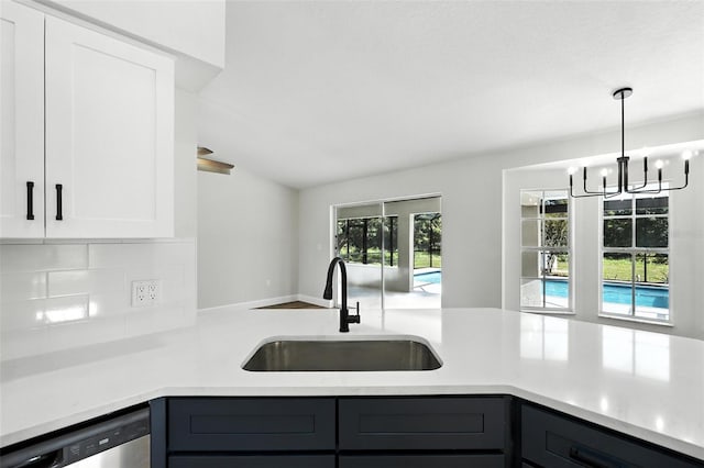 4635 Deer Run Rd, Saint Cloud, FL 34772 - kitchen with dishwasher, light countertops, tasteful backsplash, white cabinetry, and lofted ceiling