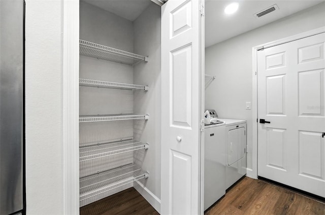 4635 Deer Run Rd, Saint Cloud, FL 34772 - laundry room featuring separate washer and dryer and dark wood finished floors