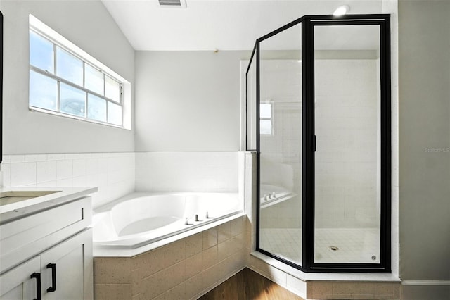 4635 Deer Run Rd, Saint Cloud, FL 34772 - full bathroom featuring a garden tub, a shower stall, vanity, and wood finished floors