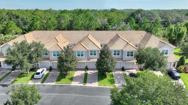 8309 Bella Vida Cir Unit 8309, Davenport, FL 33896 - aerial view of property and surrounding area featuring a forest