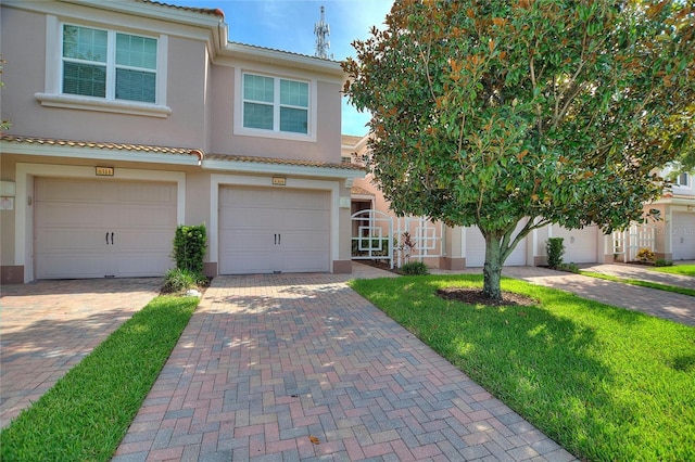 8309 Bella Vida Cir Unit 8309, Davenport, FL 33896 - mediterranean / spanish home featuring stucco siding, driveway, a garage, and a tiled roof