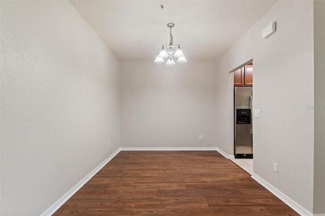 8309 Bella Vida Cir Unit 8309, Davenport, FL 33896 - unfurnished dining area featuring a chandelier and wood finished floors