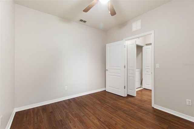 8309 Bella Vida Cir Unit 8309, Davenport, FL 33896 - unfurnished bedroom featuring dark wood finished floors, a ceiling fan, and washer / dryer