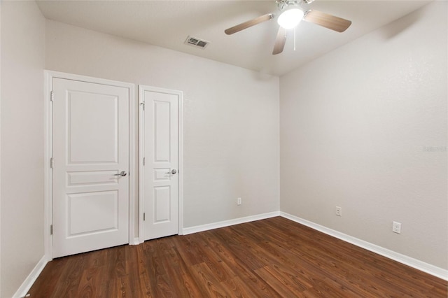 8309 Bella Vida Cir Unit 8309, Davenport, FL 33896 - unfurnished bedroom featuring dark wood-style floors and ceiling fan