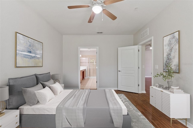8309 Bella Vida Cir Unit 8309, Davenport, FL 33896 - bedroom with wood finished floors, ceiling fan, and ensuite bath