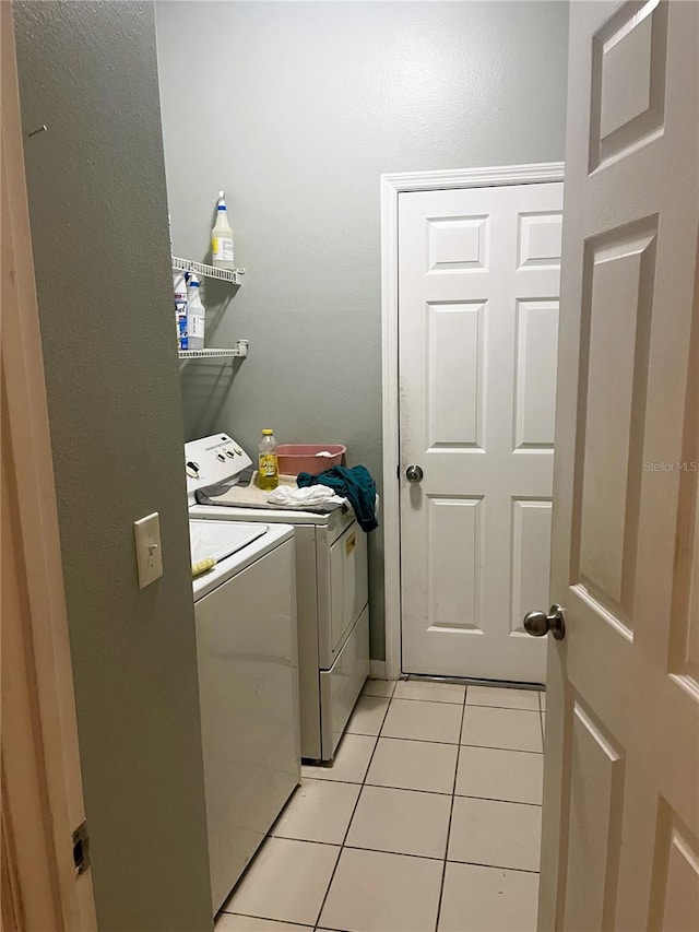 3799 Cedar Hammock Trl, Saint Cloud, FL 34772 - laundry room with independent washer and dryer and light tile patterned floors