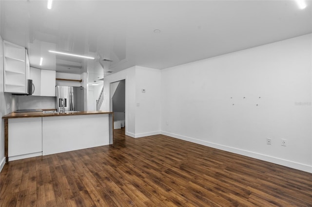 1645 Windsor Oak Ct, Kissimmee, FL 34744 - unfurnished living room featuring dark wood-style flooring and baseboards
