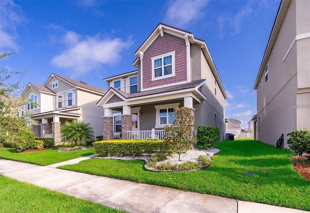 2463 Volunteer Ave, Kissimmee, FL 34744 - craftsman inspired home with a porch, a front yard, stucco siding, stone siding, and a residential view