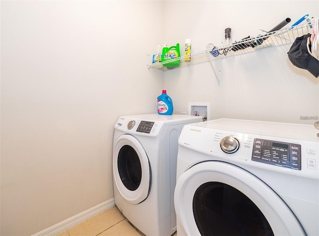 2463 Volunteer Ave, Kissimmee, FL 34744 - laundry area featuring washing machine and clothes dryer and light tile patterned floors