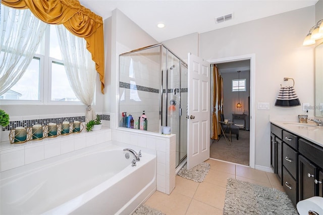 2463 Volunteer Ave, Kissimmee, FL 34744 - full bathroom featuring a bath, vanity, tile patterned flooring, a stall shower, and healthy amount of natural light