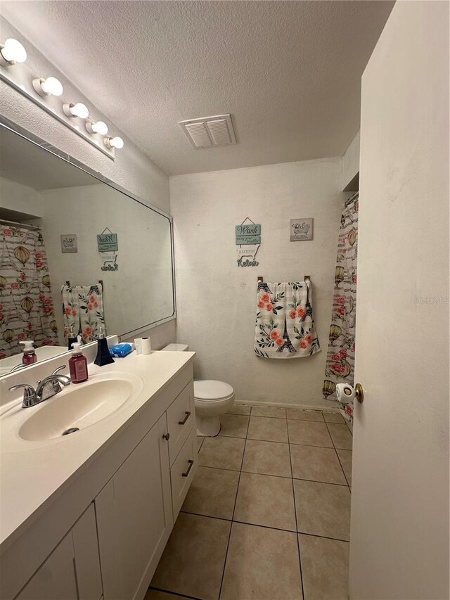 1932 Lake Atriums Cir Unit 78, Orlando, FL 32839 - bathroom featuring vanity, tile patterned flooring, a textured ceiling, and a shower with shower curtain