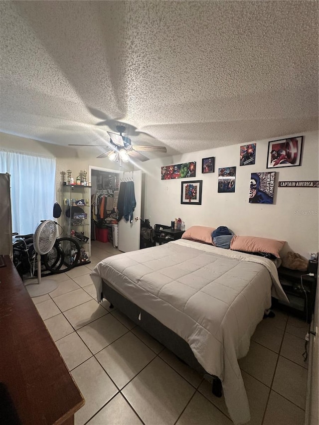 1932 Lake Atriums Cir Unit 78, Orlando, FL 32839 - bedroom featuring a textured ceiling, tile patterned flooring, a ceiling fan, and a closet