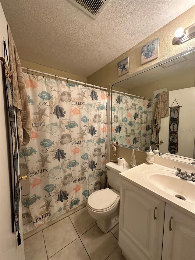 1932 Lake Atriums Cir Unit 78, Orlando, FL 32839 - bathroom with vanity, a textured ceiling, tile patterned floors, and a shower with shower curtain