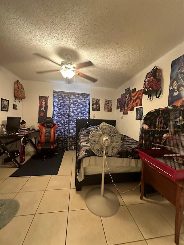 1932 Lake Atriums Cir Unit 78, Orlando, FL 32839 - tiled bedroom with a textured ceiling, a ceiling fan, and a desk