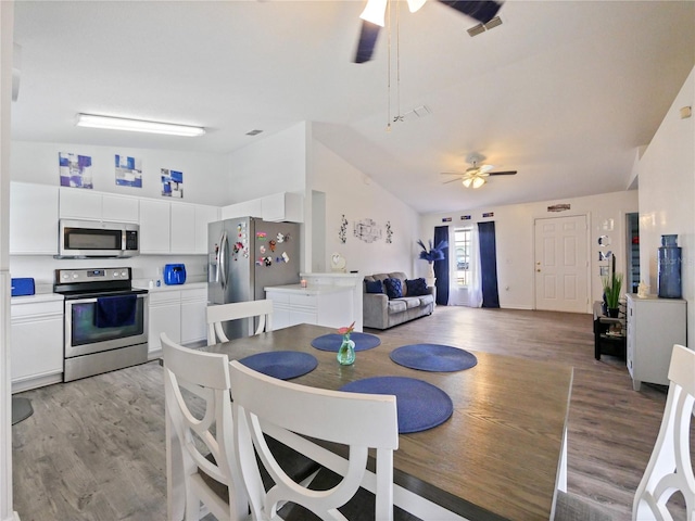 314 Clermont Dr, Kissimmee, FL 34759 - dining area featuring ceiling fan, light wood-type flooring, and high vaulted ceiling