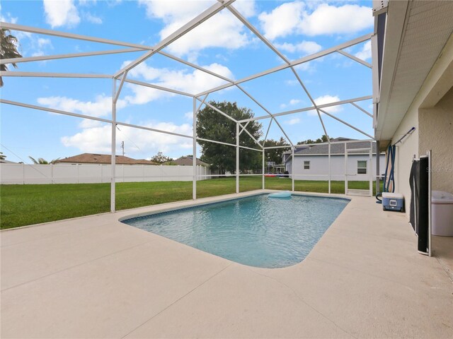 314 Clermont Dr, Kissimmee, FL 34759 - view of swimming pool featuring a yard, a patio, and glass enclosure