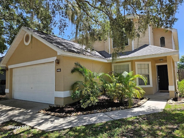 407 Darlington Loop, Davenport, FL 33896 - view of front of home featuring a garage, roof with shingles, and concrete driveway