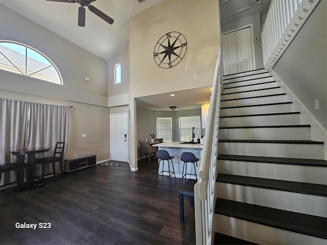 407 Darlington Loop, Davenport, FL 33896 - entrance foyer with high vaulted ceiling, dark wood-style flooring, ceiling fan, and stairs