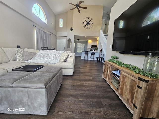 407 Darlington Loop, Davenport, FL 33896 - living room featuring dark wood finished floors, ceiling fan, high vaulted ceiling, and stairway