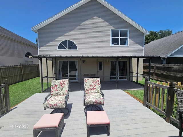 407 Darlington Loop, Davenport, FL 33896 - rear view of property featuring a wooden deck and a fenced backyard