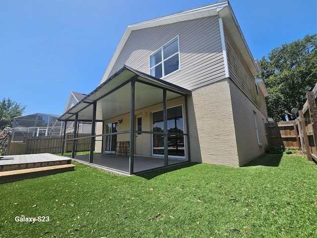 407 Darlington Loop, Davenport, FL 33896 - rear view of property featuring a fenced backyard, stucco siding, and a patio area
