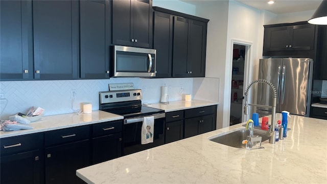 1089 Turquoise Waves Cv, Kissimmee, FL 34747 - kitchen featuring stainless steel appliances, light stone counters, backsplash, and dark cabinets
