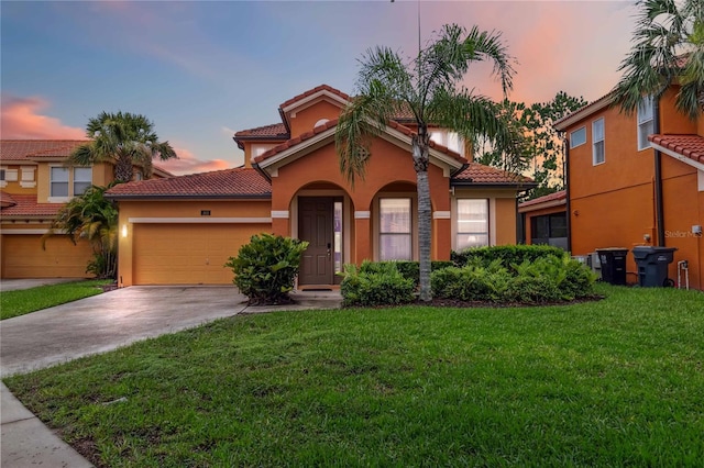 163 Tigerlily Ct, Davenport, FL 33837 - mediterranean / spanish home featuring a tile roof, an attached garage, a yard, and stucco siding