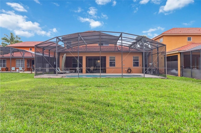 163 Tigerlily Ct, Davenport, FL 33837 - back of property featuring a tiled roof, a lawn, a patio area, stucco siding, and an outdoor pool
