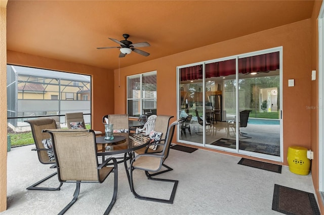 163 Tigerlily Ct, Davenport, FL 33837 - view of patio / terrace featuring a ceiling fan, outdoor dining space, and glass enclosure