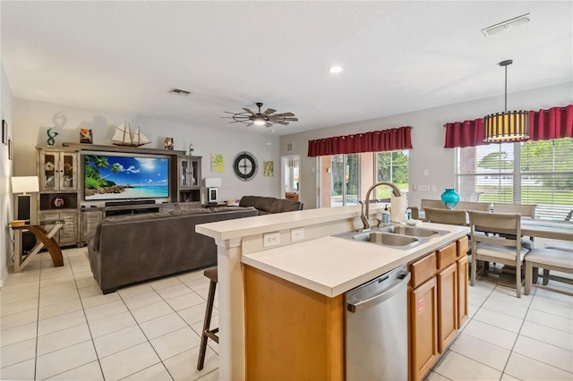 163 Tigerlily Ct, Davenport, FL 33837 - kitchen featuring dishwasher, light tile patterned flooring, light countertops, a center island with sink, and recessed lighting