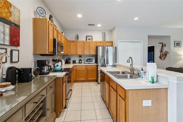 163 Tigerlily Ct, Davenport, FL 33837 - kitchen featuring light tile patterned flooring, a center island with sink, stainless steel appliances, light countertops, and recessed lighting