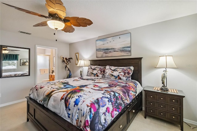 163 Tigerlily Ct, Davenport, FL 33837 - bedroom with light colored carpet, connected bathroom, and a ceiling fan