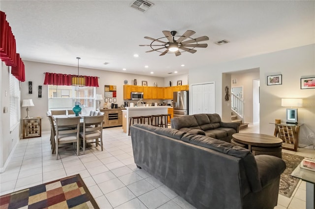 163 Tigerlily Ct, Davenport, FL 33837 - living area featuring ceiling fan, light tile patterned flooring, recessed lighting, and stairs