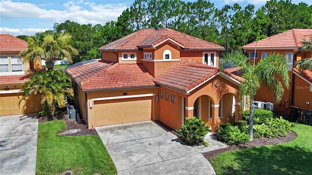 163 Tigerlily Ct, Davenport, FL 33837 - mediterranean / spanish house with stucco siding, a tiled roof, concrete driveway, an attached garage, and a front yard