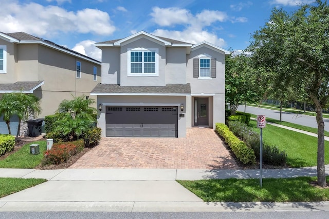 7403 Marker Ave, Kissimmee, FL 34747 - traditional home with decorative driveway, stucco siding, an attached garage, and a shingled roof