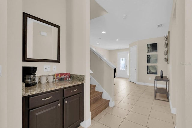 7403 Marker Ave, Kissimmee, FL 34747 - hallway with light tile patterned flooring, stairway, and recessed lighting