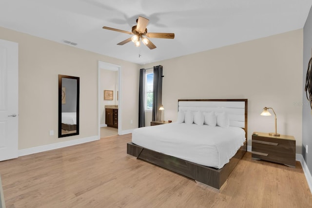 7403 Marker Ave, Kissimmee, FL 34747 - bedroom featuring light wood-type flooring, a ceiling fan, and ensuite bath