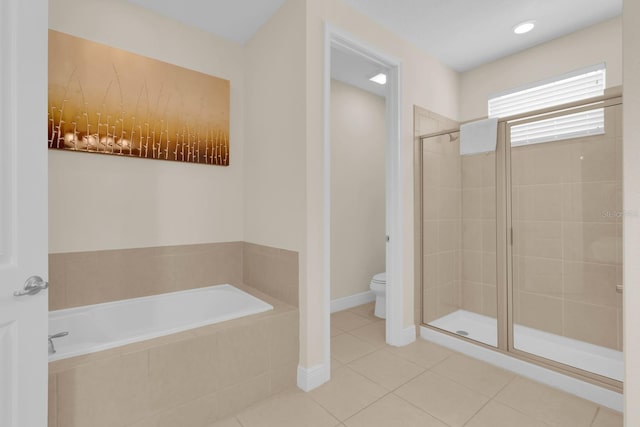 7403 Marker Ave, Kissimmee, FL 34747 - bathroom with a bath, a stall shower, and tile patterned flooring