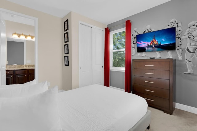 7403 Marker Ave, Kissimmee, FL 34747 - bedroom featuring a closet, light colored carpet, and ensuite bath