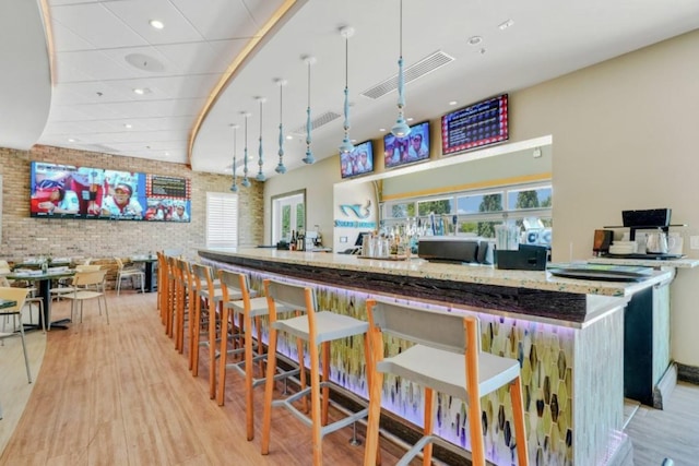 7403 Marker Ave, Kissimmee, FL 34747 - bar with plenty of natural light, brick wall, light wood-style flooring, and recessed lighting