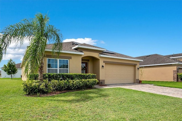 3430 Harlequin Dr, Saint Cloud, FL 34772 - view of front of property with stucco siding, an attached garage, solar panels, decorative driveway, and a front yard
